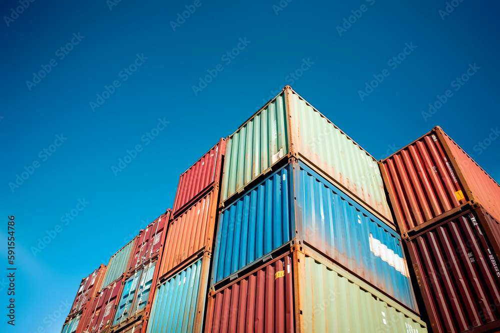 Fototapeta premium Shipping containers stacked against blue sky. Generative ai