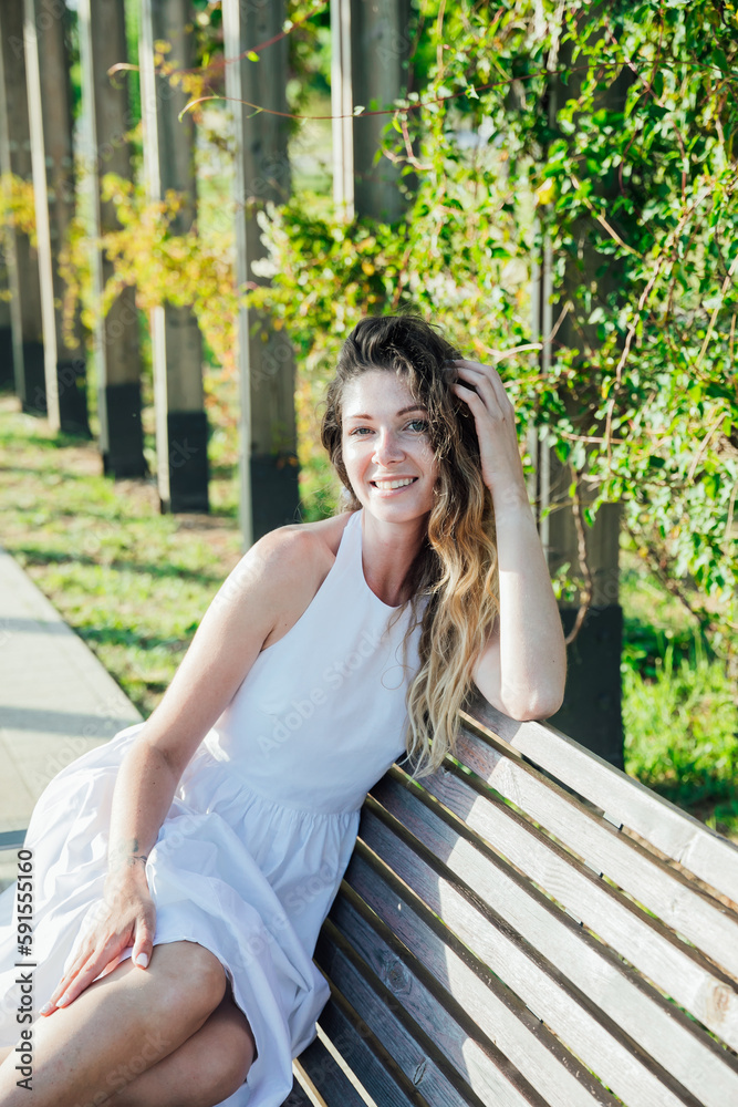 woman sitting on a park bench walk woman sitting on a park bench walk