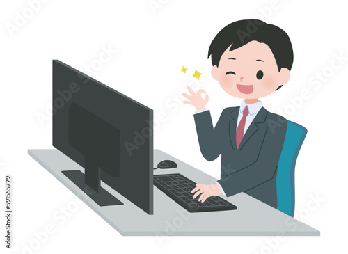 パソコンの前でグッドサインを出すスーツの男性