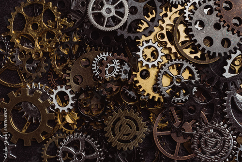 Shiny gears of cold steel colors on dark background