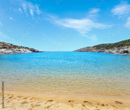 Summer sea scenery with aquamarine transparent water and sandy Agridia Beach. View from shore (Sithonia, Halkidiki, Greece).
