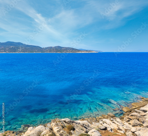 Summer stony Aegean sea coast (Halkidiki, Sithonia, Greece).