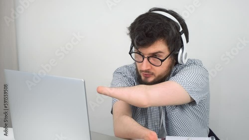 Handicapped disabled man with amputated two stump hands talking videocall on laptop at home sitting on sofa. Problem of adaptation to life people with disabilities. Independent Invalid person.