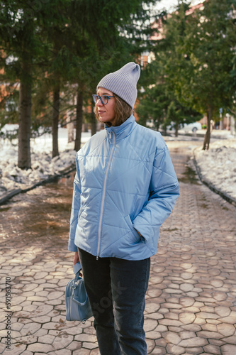 Portrait of a stylish woman in blue jacket. Spring outdoor portrait.