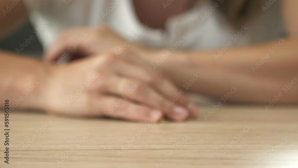 Woman's hand pulls up a stack of bitcoins and hides them under her palm. Woman's hand pulls up a stack of bitcoins and hides them under her palm.