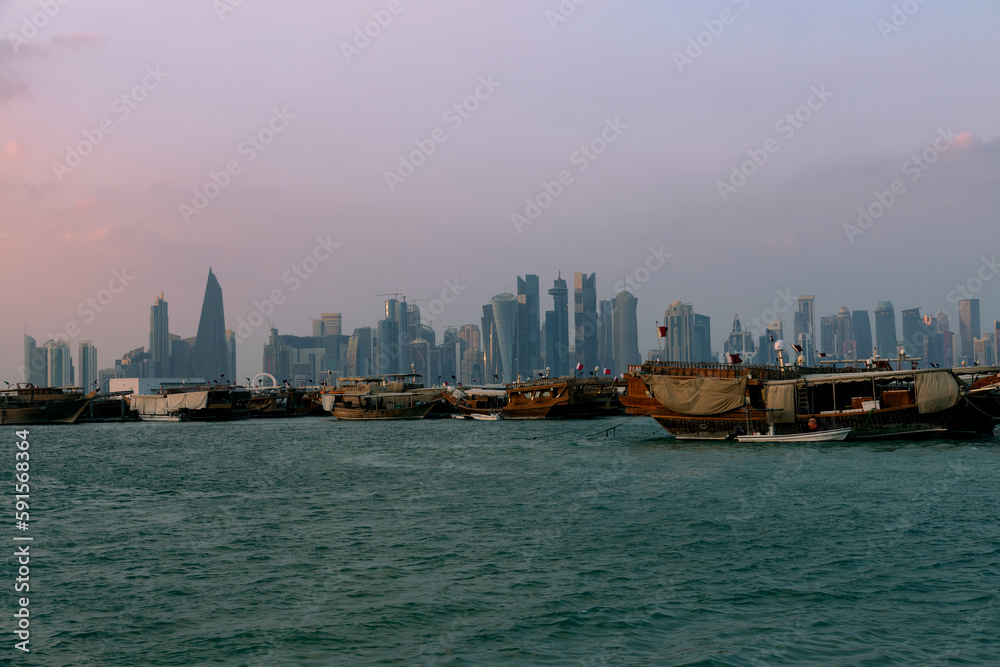 Doha, Qatar - December 12 2022: View of the Beach and sailing ships and towers in Doha Corniche in Qatar