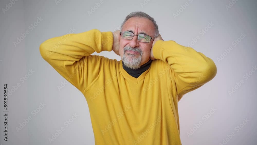 Disappointed man 70s grabbing his head or covering ears while screaming due to annoying noise, isolated over white background Disappointed man 70s grabbing his head or covering ears while screaming due to annoying noise, isolated over white background