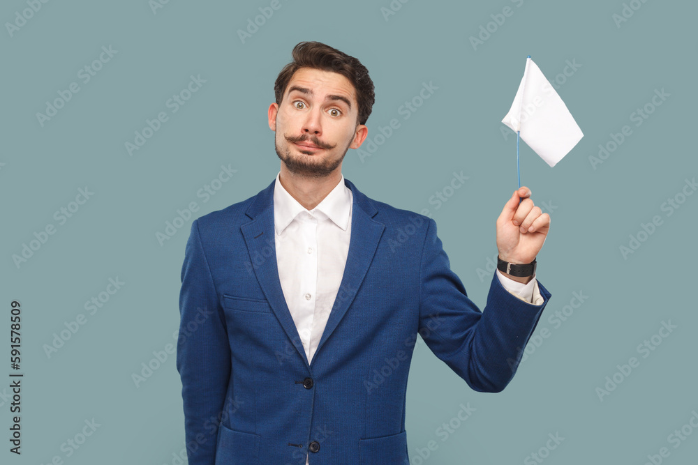 Portrait of unhappy sad attractive man with mustache standing with white flag, giving up, wearing official style suit. Indoor studio shot isolated on light blue background. Portrait of unhappy sad attractive man with mustache standing with white flag, giving up, wearing official style suit. Indoor studio shot isolated on light blue background.
