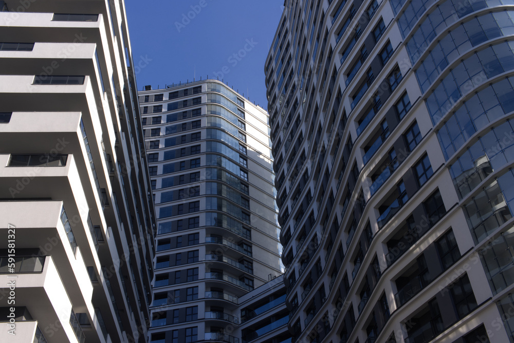 Facades of large residential buildings against the blue sky. Facades of large residential buildings against the blue sky.