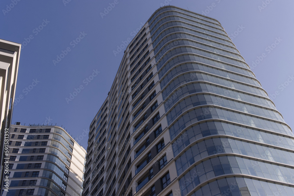 Facades of large residential buildings against the blue sky.