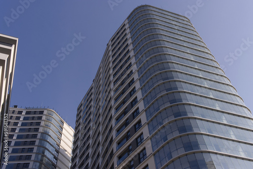 Facades of large residential buildings against the blue sky.