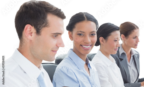 Portrait of smiling businesswoman with colleagues in conference