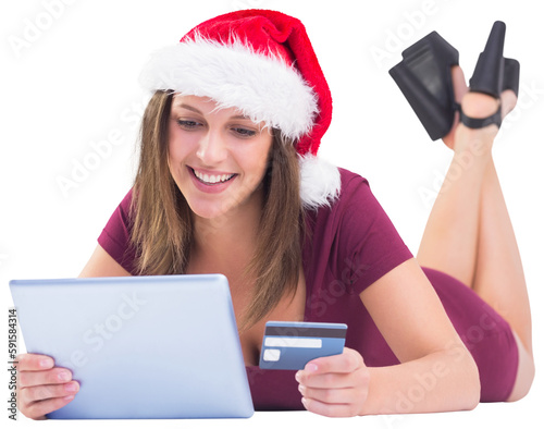 Festive brunette shopping online with tablet