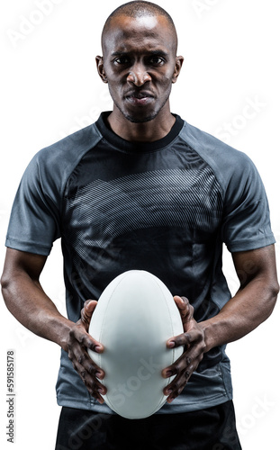 Portrait of serious athlete holding rugby ball