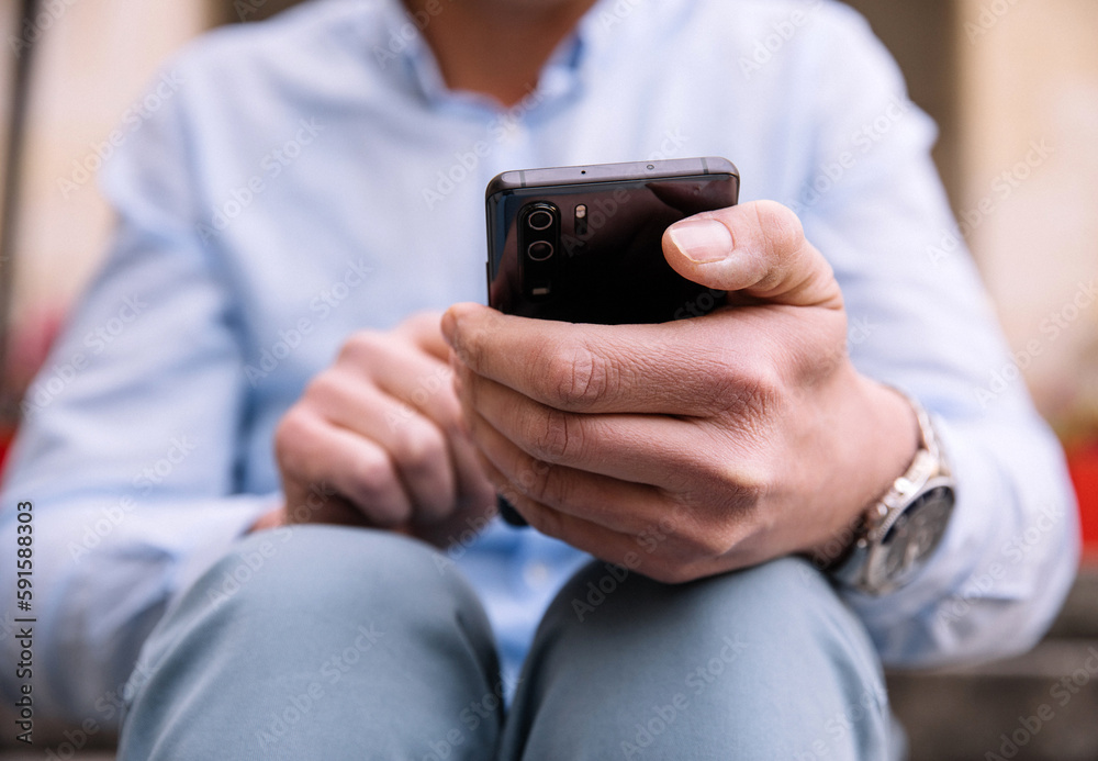 A business person with a smartphone in the city. Business vision, communications, online shopping. A business person with a smartphone in the city. Business vision, communications, online shopping.