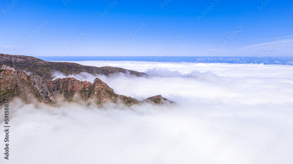 Mountains jut through the cloud cover at Pico do Arieiro on Madeira in Portugal