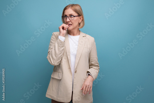 pensive 50s mature woman on plain background with copy space