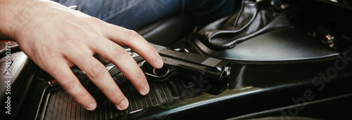 Man driving a car with gun © Daniel