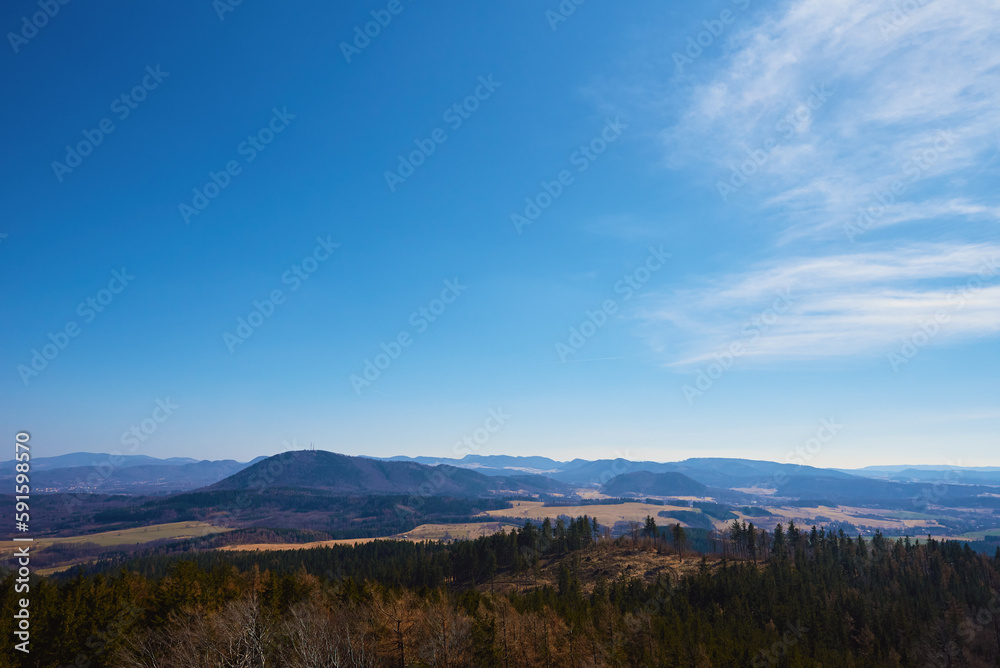 Beautiful mountains covered with evergreen forest on sunny day. Natural landscape with mountain ranges and valleys Beautiful mountains covered with evergreen forest on sunny day. Natural landscape with mountain ranges and valleys