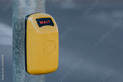 yellow button at pedestrian crossing 