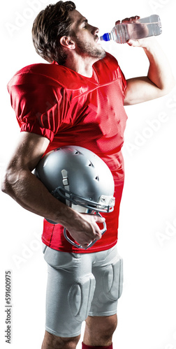 Thirsty American football player in red jersey drinking water 
