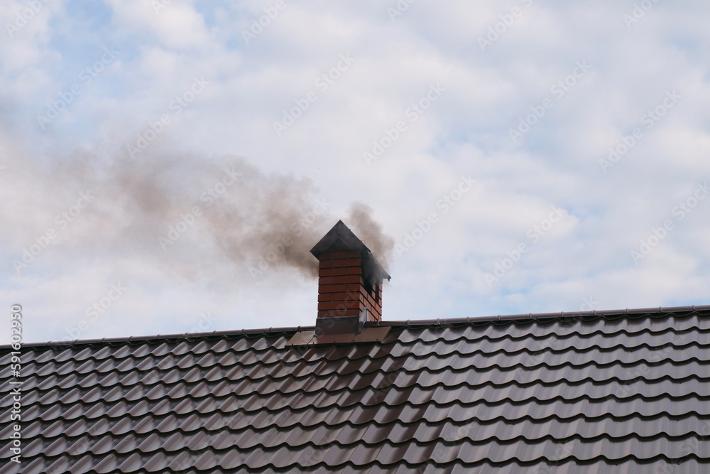 smoke comes from the chimney of the house