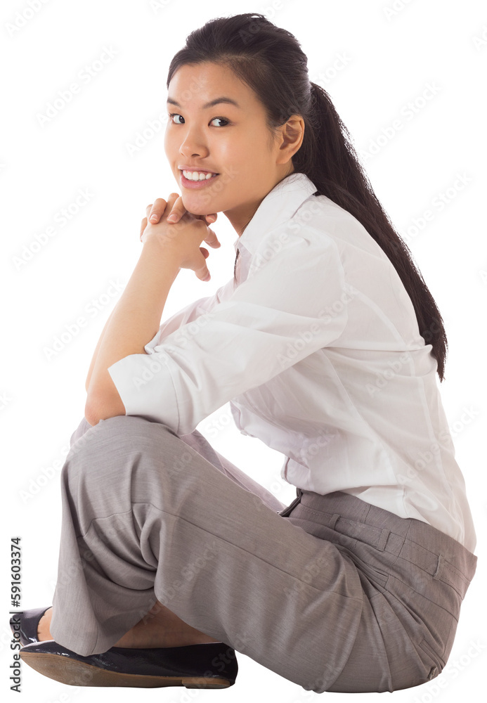 Businesswoman sitting cross legged with hands together Businesswoman sitting cross legged with hands together