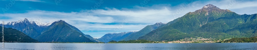 Lake Como (Italy) summer cloudy view with snow on mount top. Panorama.