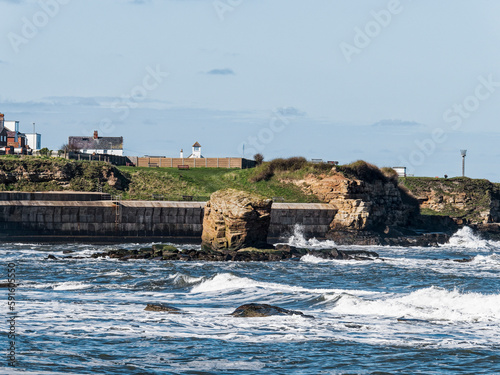 View over Collywell Bay with Charlie's Garden rock formation to Seaton Sluice, Northumberland, UK photo