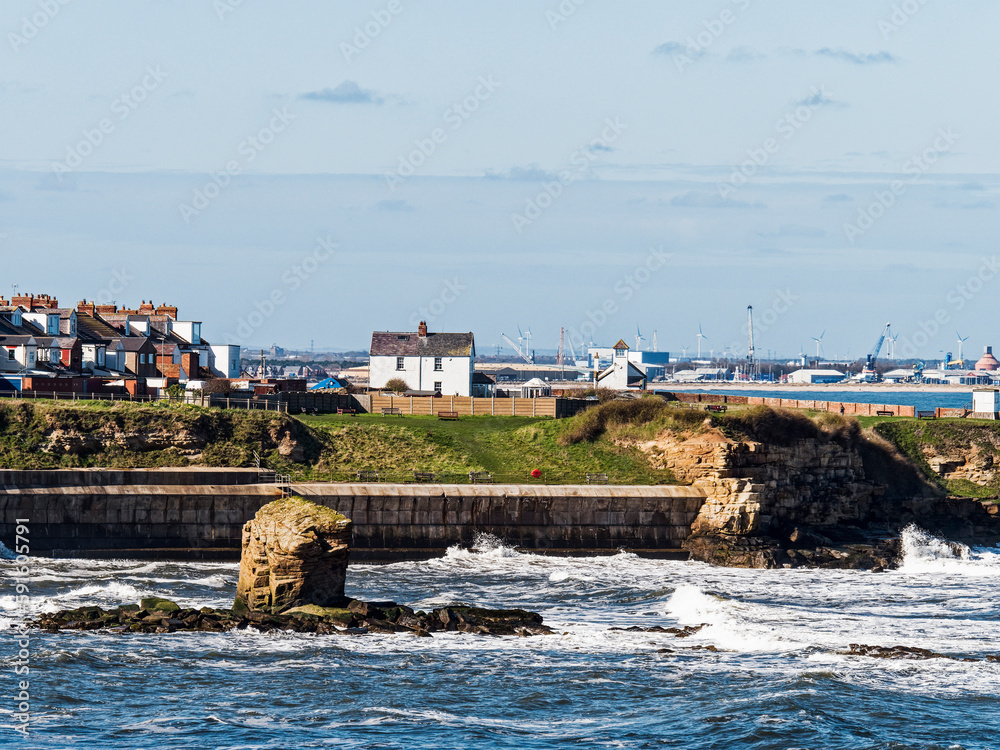 View over Collywell Bay with Charlie's Garden rock formation to Seaton Sluice and Blyth, Northumberland, UK
