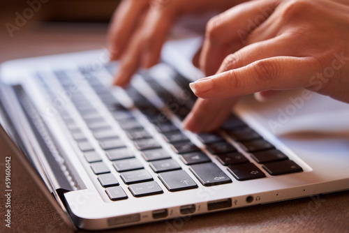 Close-up of the hands of businesswoman typing with a laptop