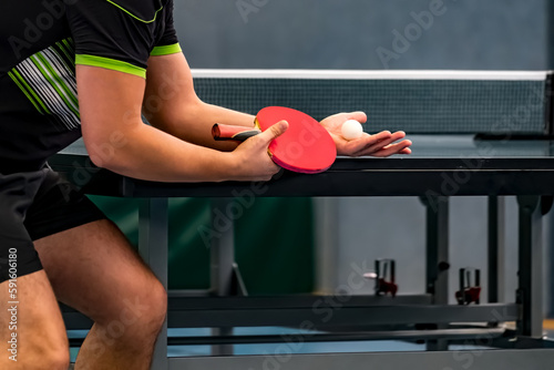 close up of a professional table tennis player serving