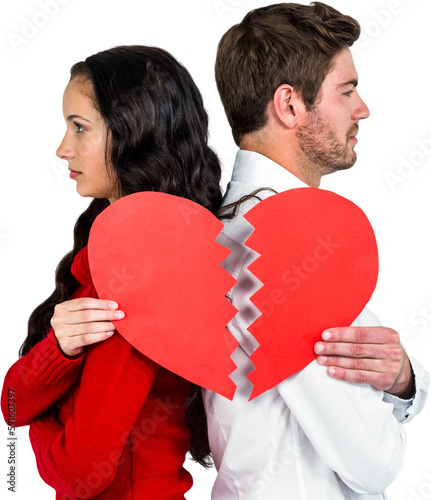Couple back to back holding heart halves
