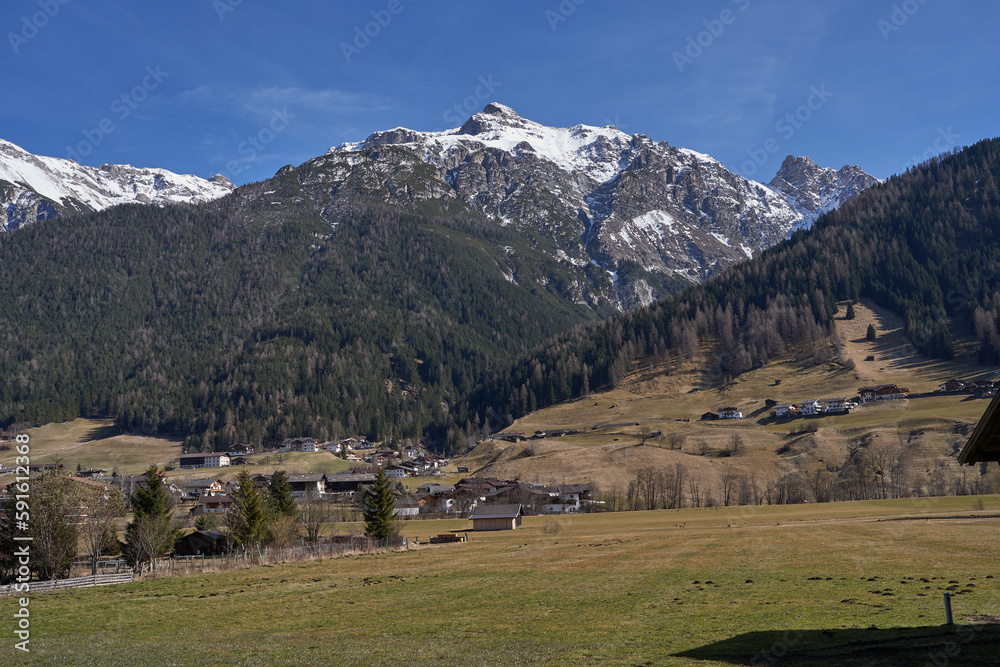 Kampl, Austria - March 16, 2023 - meadows and grasslands in an alpine valley Stubaital at the end of the winter season