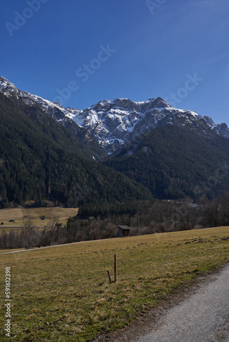 Kampl, Austria - March 16, 2023 - meadows and grasslands in an alpine valley Stubaital at the end of the winter season photo