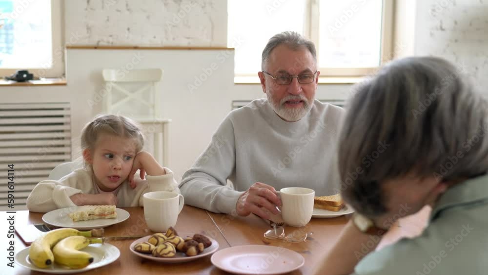 Caucasian couple in love enjoying weekend breakfast with cute grandchild talking about childhood and relationship in home interior, happy family eating sandwiches togetherness
Caucasian couple in love enjoying weekend breakfast with cute grandchild talking about childhood and relationship in home interior, happy family eating sandwiches togetherness