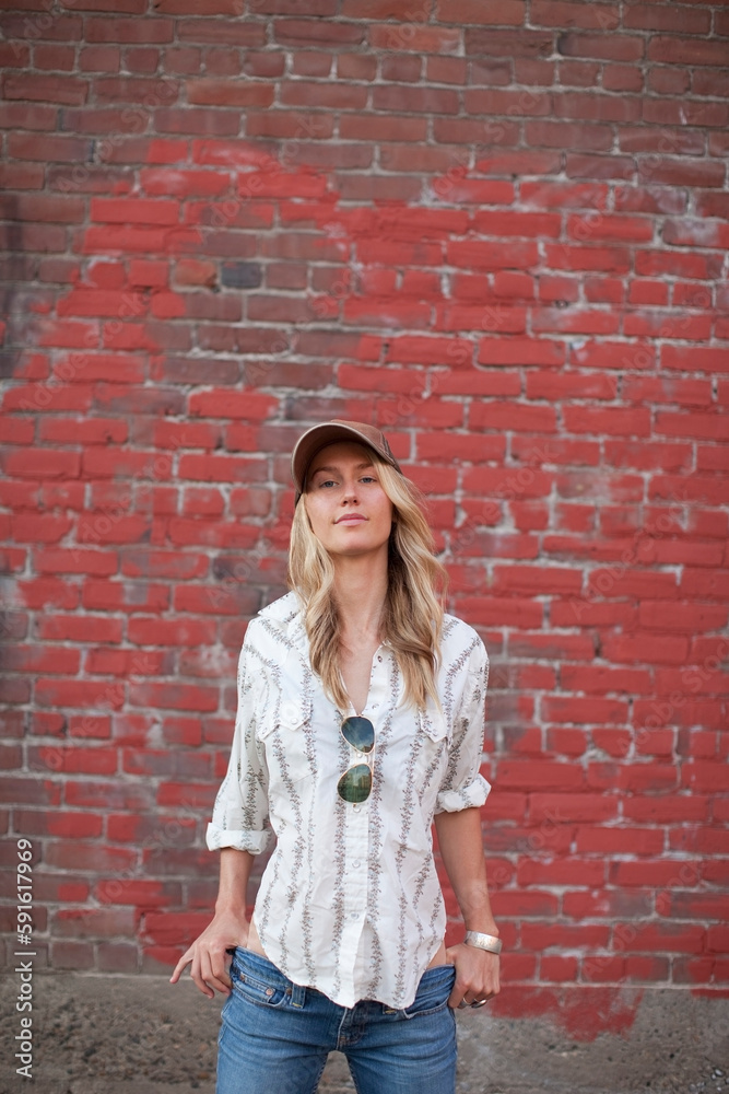 Portrait of Woman Standing in Front of Brick Wall Portrait of Woman Standing in Front of Brick Wall