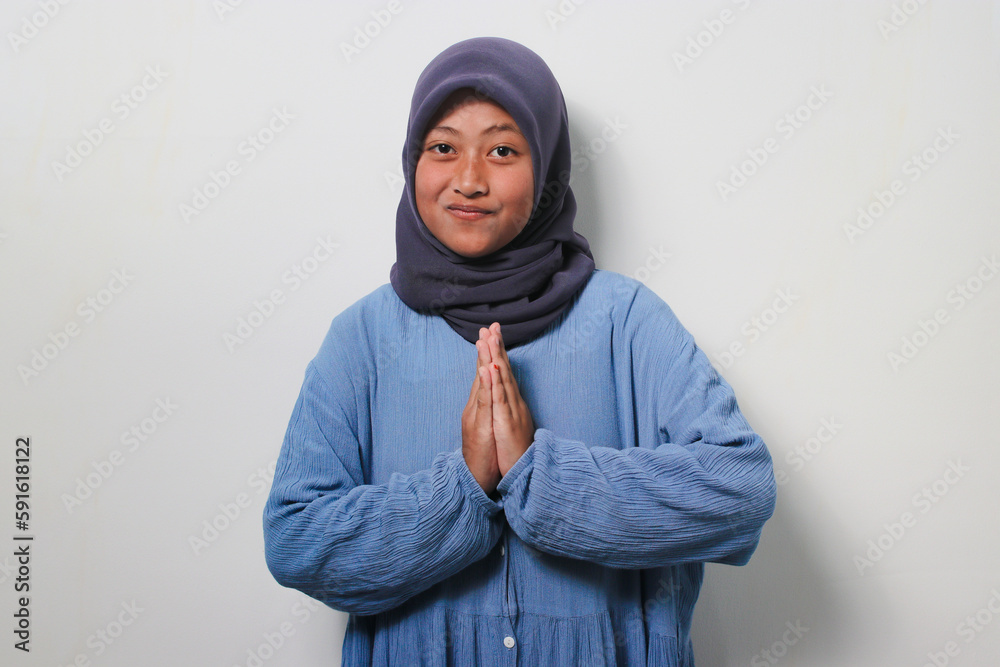 Smiling young Asian girl gesturing eid mubarak Smiling young Asian girl gesturing eid mubarak