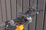 Close-up view of brake system on bicycle handlebar.