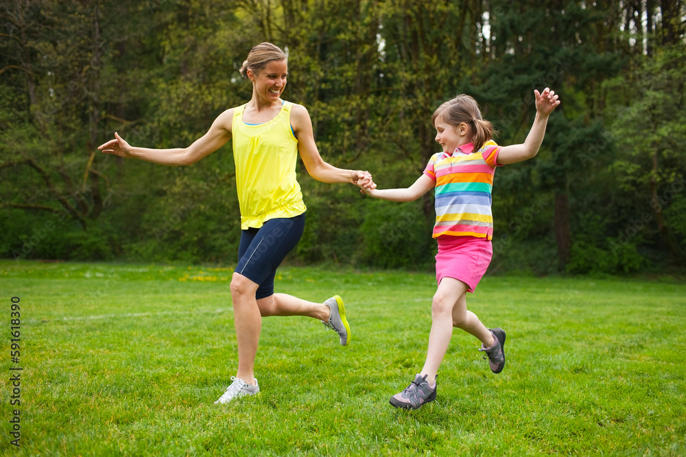 Mother and Young Daughter Exercising in the Park, Portland, Oregon, USA Mother and Young Daughter Exercising in the Park, Portland, Oregon, USA