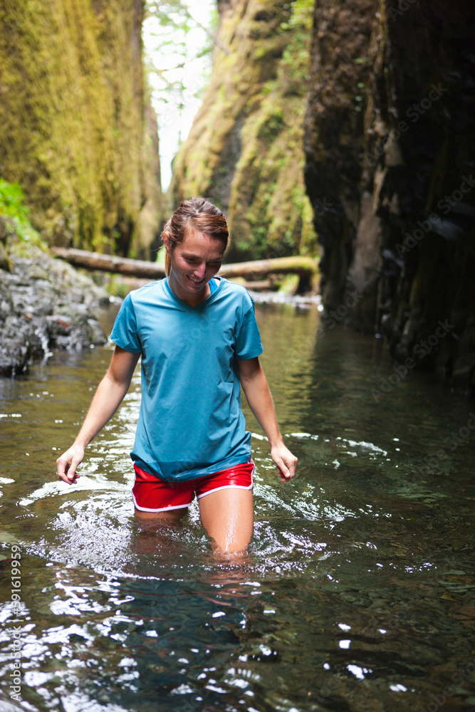 Woman Hiking through River, Oneonta Gorge, Oregon, USA