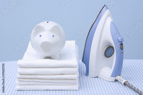 Iron, Folded Laundry and Piggy Bank