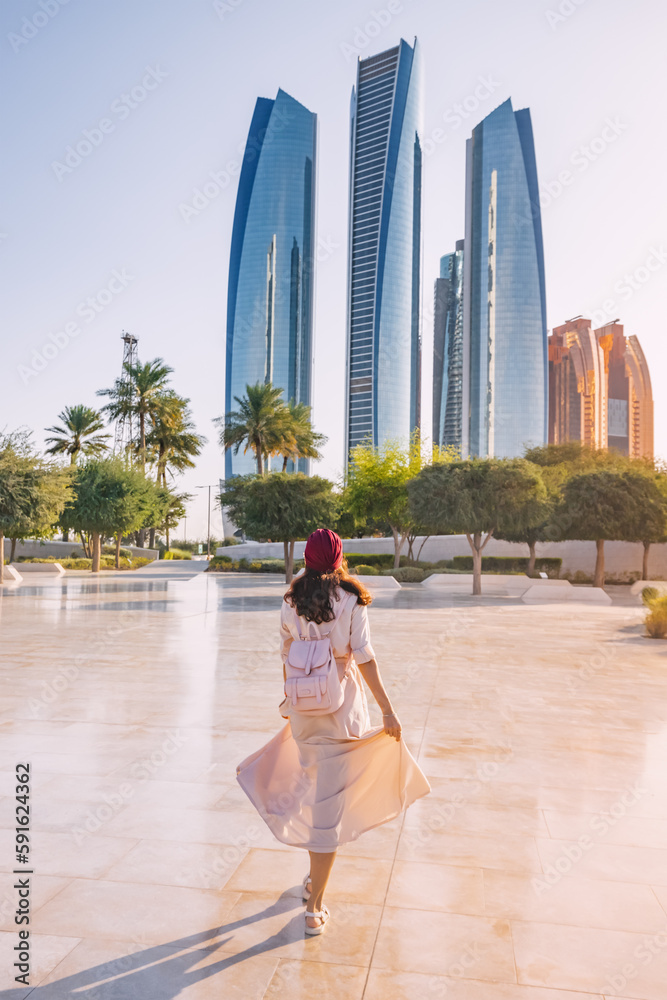 Revel in the beauty of Abu Dhabi's breathtaking architecture and multicultural vibrancy, embodied by the elegant figure of an Indian woman.