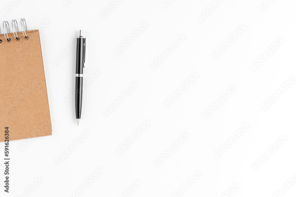 Modern office desktop with notebook and pen on white background. Business background Modern office desktop with notebook and pen on white background. Business background