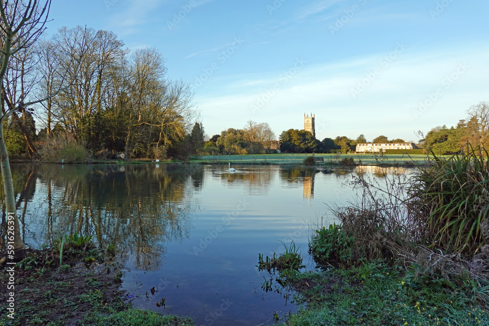 Fototapeta premium reflection of trees in the lake situated in the Cotswold town of Cirencester. Gloucestershire. UK
