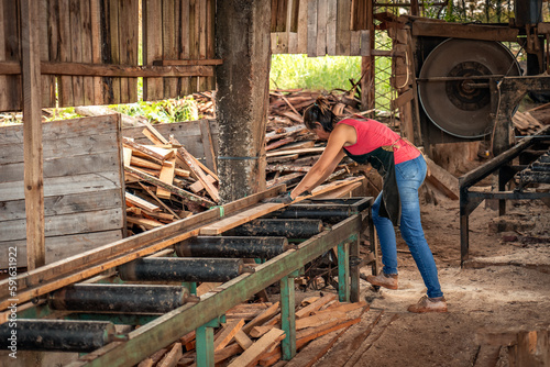 Portrait of adult industrial woman working in a wood shop. © daniromphoto