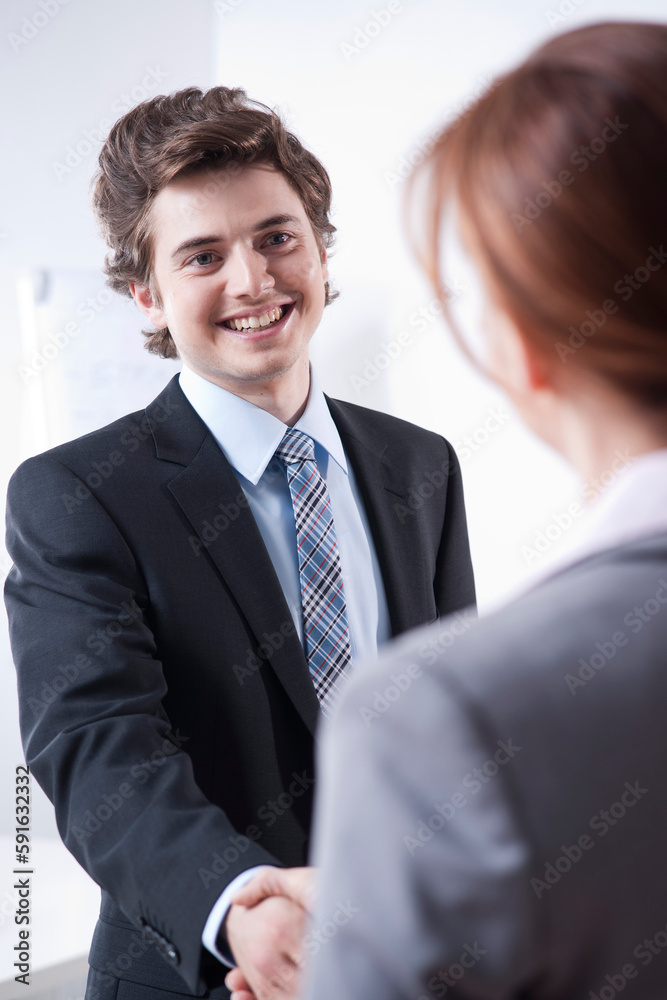 Young Businessman Shaking Hands with Businesswoman Young Businessman Shaking Hands with Businesswoman