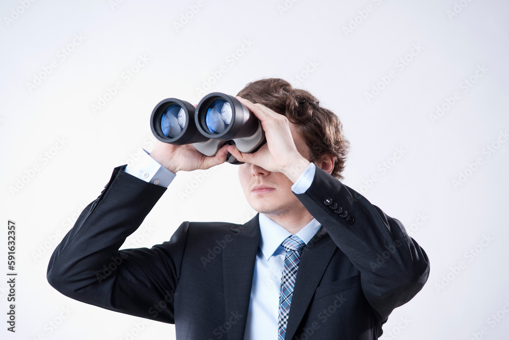 Young Businessman Looking through Binoculars Young Businessman Looking through Binoculars