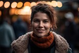 Portrait of a beautiful smiling young woman in the city at night