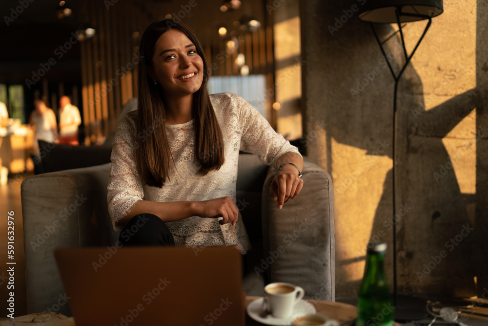 Smiling young woman on a coffee date